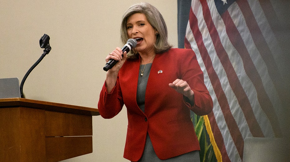 Senator Joni Ernst speaks with microphone