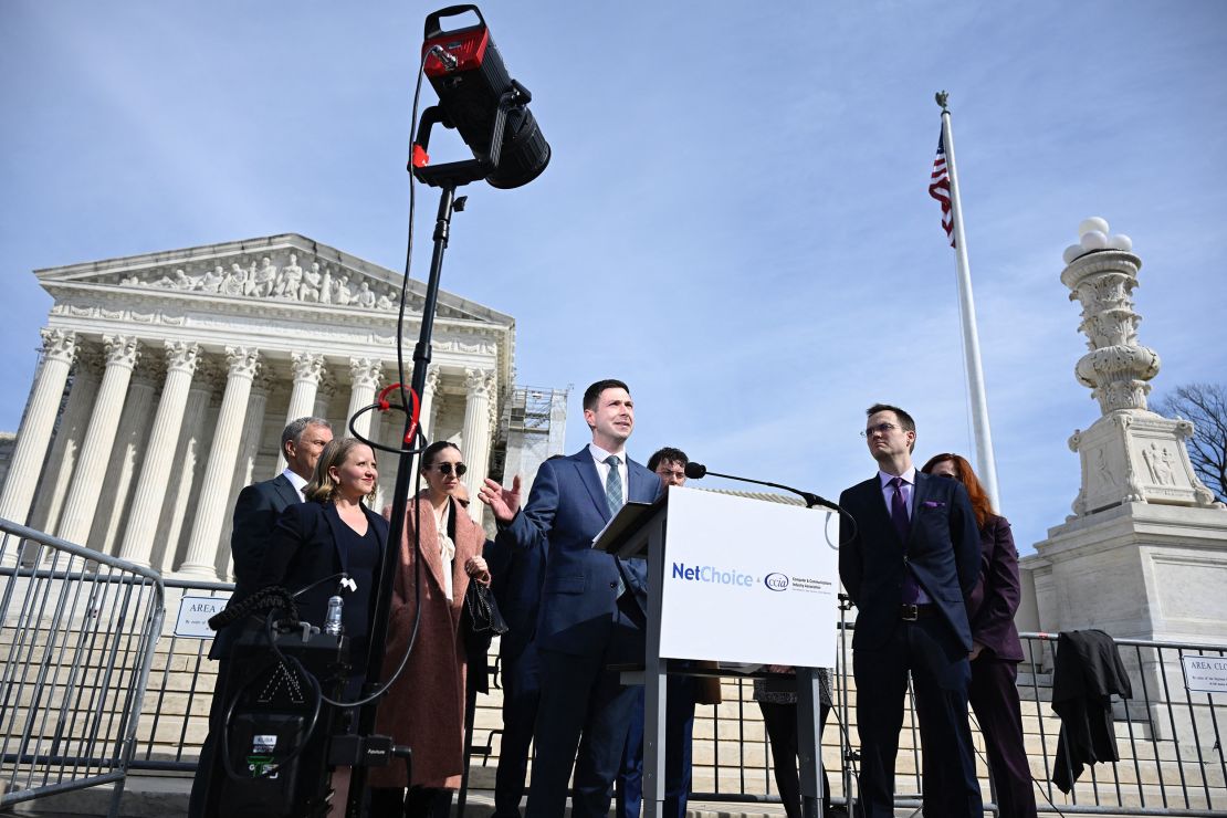 Chris Marchese (C), Director of NetChoice Litigation Center, speaks to the press outside the US Supreme Court in Washington, DC on February 26, 2024. In a case that could determine the future of social media, the US Supreme Court was asked today to decide whether a pair of state laws that limit content moderation are constitutional. (Photo by ANDREW CABALLERO-REYNOLDS / AFP) (Photo by ANDREW CABALLERO-REYNOLDS/AFP via Getty Images)