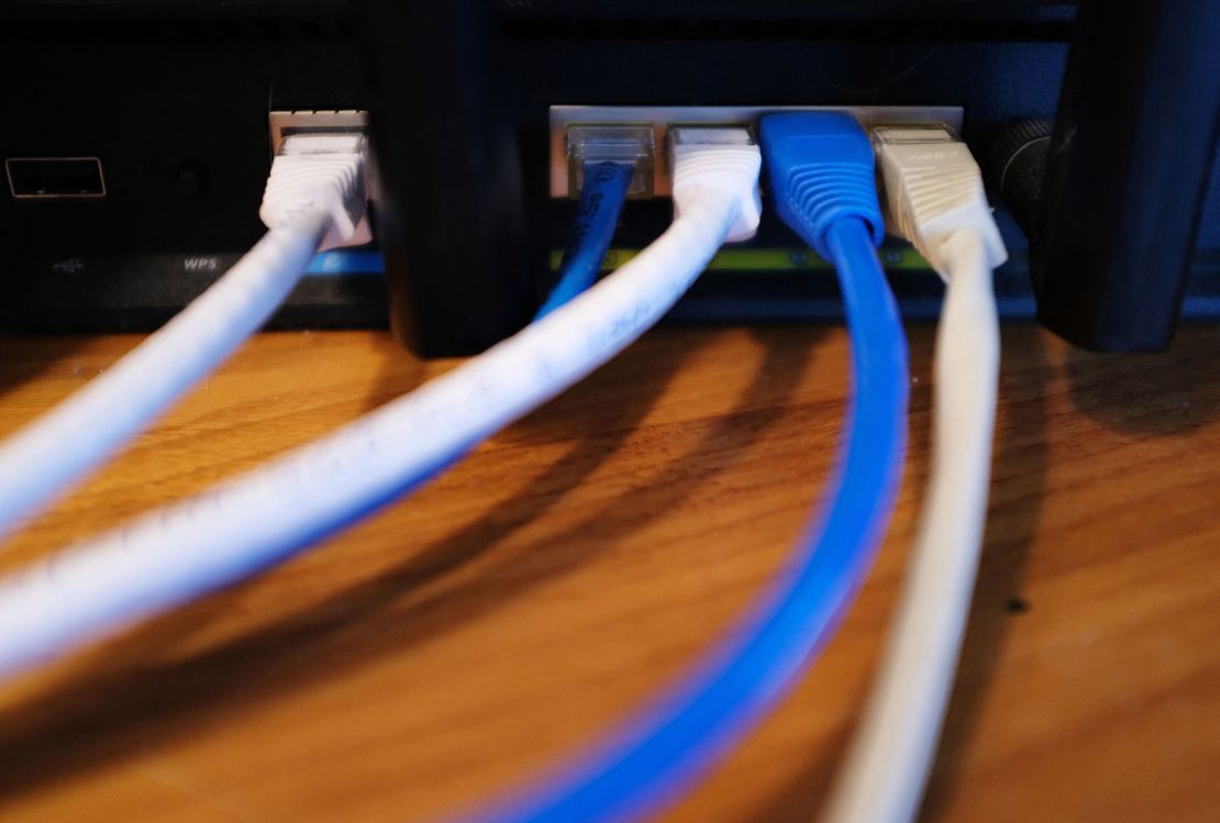 Ethernet cables are seen running from the back of a wireless router in Washington, DC on March 21, 2019.