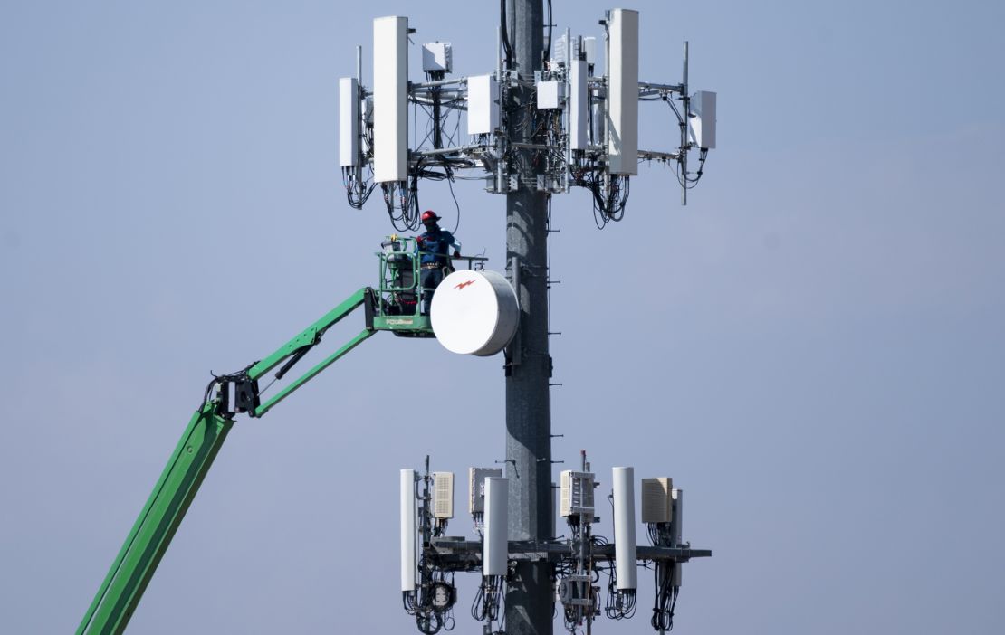 A crew works on a cell tower in Lake Havasu City, Ariz., on Tuesday, August 24, 2021.